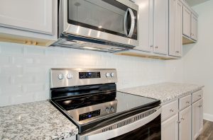 stove and microwave and granite countertops