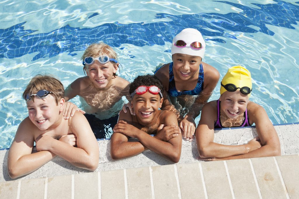 Multiracial group of five children in swimming pool, westgate