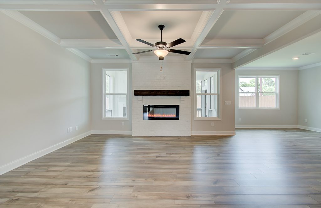 electric fireplace and coffered ceilings