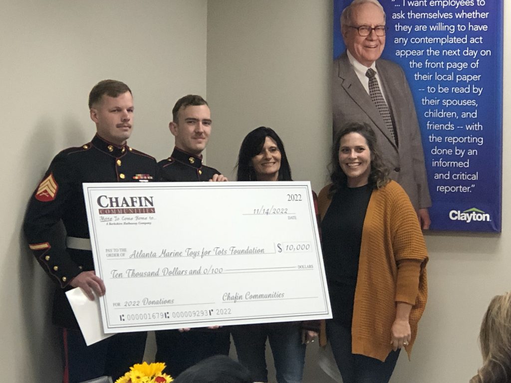 chafin communities presents check to toys for tots